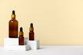 Composition brown glass bottles with aromatic natural essential oil. Cosmetic product on white geometric podium. Alternative