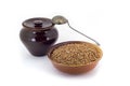 The composition of the Buckwheat groats in a clay pial next to a clay pot and a copper spoon, Royalty Free Stock Photo