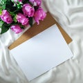 Composition with a bunch of flowers and blank piece of paper on the white cloth Royalty Free Stock Photo