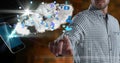 Composition of businessman using interactive screen with smartphone, cloud and digital icons