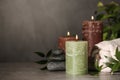 Composition with candles and spa stones on grey table Royalty Free Stock Photo