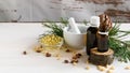 composition of cedar oil with pine nuts on a background of a branch with a pine cone, on a light wooden background