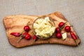 Composition with cheese pieces in olive oil and hot peppers