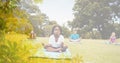 Composition of children practicing yoga on yoga mats in park with tree overlay