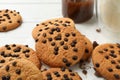 Composition with chip cookies milk and caramel on white wooden table Royalty Free Stock Photo