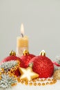 Composition with Christmas baubles, gold star and fir branch on white snow. Christmas card background Royalty Free Stock Photo