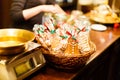 The composition of the Christmas cookies in the straw basket at the blurred background of the shop.
