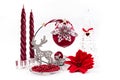 The Composition of christmas decorations with silver brocade reindeer and red candles