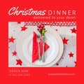 Composition of christmas dinner text over christmas place setting with red stars on white tablecloth Royalty Free Stock Photo