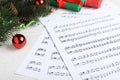 Composition with Christmas music sheets with notes on white wooden background, closeup Royalty Free Stock Photo