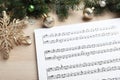 Composition with Christmas music sheets on wooden background, closeup Royalty Free Stock Photo