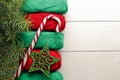 Composition with Christmas tree and, candy stick, yarn balls as decorations on wooden background Royalty Free Stock Photo