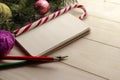Composition with Christmas tree, notebook and yarn balls as decorations on wooden background Royalty Free Stock Photo