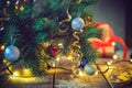 Composition of Christmas tree in vase with decorations, gifts and lights on the wooden vintage table. Retro style Christmas backgr Royalty Free Stock Photo