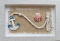 Composition with clay anchor, white rope and seashell