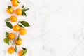 Composition of Clementines on White Marble Background