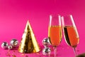 Composition of close up of new years champagne and decorations on pink background