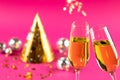 Composition of close up of new years champagne and decorations on pink background