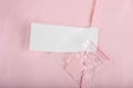 Composition clothes label with tissue samples on pink knitted background, close up Royalty Free Stock Photo
