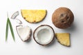 Composition with coconuts, juicy and leaves slices on white background, top view