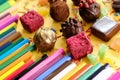 Composition of colored pencils and beautiful sweets Royalty Free Stock Photo