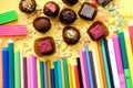 Composition of colored pencils and beautiful sweets Royalty Free Stock Photo