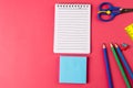 Composition of colorful school equipment with notebook and post it on blue and pink surface Royalty Free Stock Photo