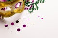 Composition of colourful mardi gras beads and carnival mask on white background with copy space Royalty Free Stock Photo