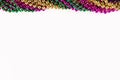 Composition of colourful mardi gras beads with copy space on white background with copy space Royalty Free Stock Photo