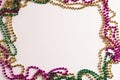 Composition of colourful mardi gras beads on white background, with copy space Royalty Free Stock Photo
