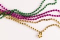 Composition of colourful mardi gras beads on white background with copy space Royalty Free Stock Photo