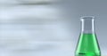 Composition of conical flask of green liquid, with blurred copy space