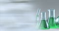 Composition of conical flasks of green liquid and stirrer, with blurred copy space Royalty Free Stock Photo