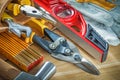Composition of construction tooling in toolbelt on wooden board Royalty Free Stock Photo