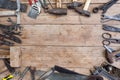 Composition of construction tools on an old battered wooden surface of tools: pliers, pipe wrench, screwdriver, hammer, metal shea Royalty Free Stock Photo