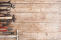 Composition of construction tools on an old battered wooden surface of tools: pliers, pipe wrench, screwdriver, hammer, metal shea Royalty Free Stock Photo