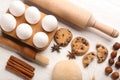 Composition with cookies and ingredients for preparing pastries on wooden background