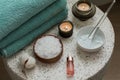 Composition with cosmetic alginate facial mask for spa treatments, aroma oil, epsom or magnium salt, candles and terry towels on a Royalty Free Stock Photo