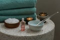 Composition with cosmetic alginate facial mask for spa treatments, aroma oil, epsom or magnium salt, candles and terry towels on a Royalty Free Stock Photo