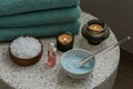 Composition with cosmetic alginate facial mask for spa treatments, aroma oil, epsom or magnium salt, candles and terry towels on a Royalty Free Stock Photo