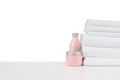 Composition of cosmetic bottles and towels isolated on white Royalty Free Stock Photo