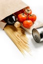 Composition with craft bag, spaghetti, tomatoes, rice, canned goods and olive oil isolated on a white background Royalty Free Stock Photo