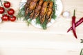 Composition with crayfish on the white plate, pepper, tomatoes, garlic, dill on the dark wood background. Cooking food background