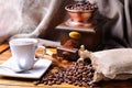 Composition with a cup of coffee, beans and coffee grinder Royalty Free Stock Photo