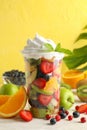 Composition cup of fresh fruit salad on white wooden table Royalty Free Stock Photo