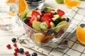 Composition with cup of fresh fruit salad on wooden table, close up Royalty Free Stock Photo