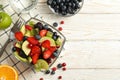 Composition with cup of fresh fruit salad on wooden table, top view Royalty Free Stock Photo