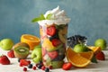 Composition with cup of fresh fruit salad on background Royalty Free Stock Photo