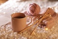 Composition with cup of hot beverage and knitting yarn on fuzzy rug. Winter Royalty Free Stock Photo