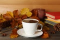 Composition with cup of hot coffee and autumn leaves on wooden table Royalty Free Stock Photo